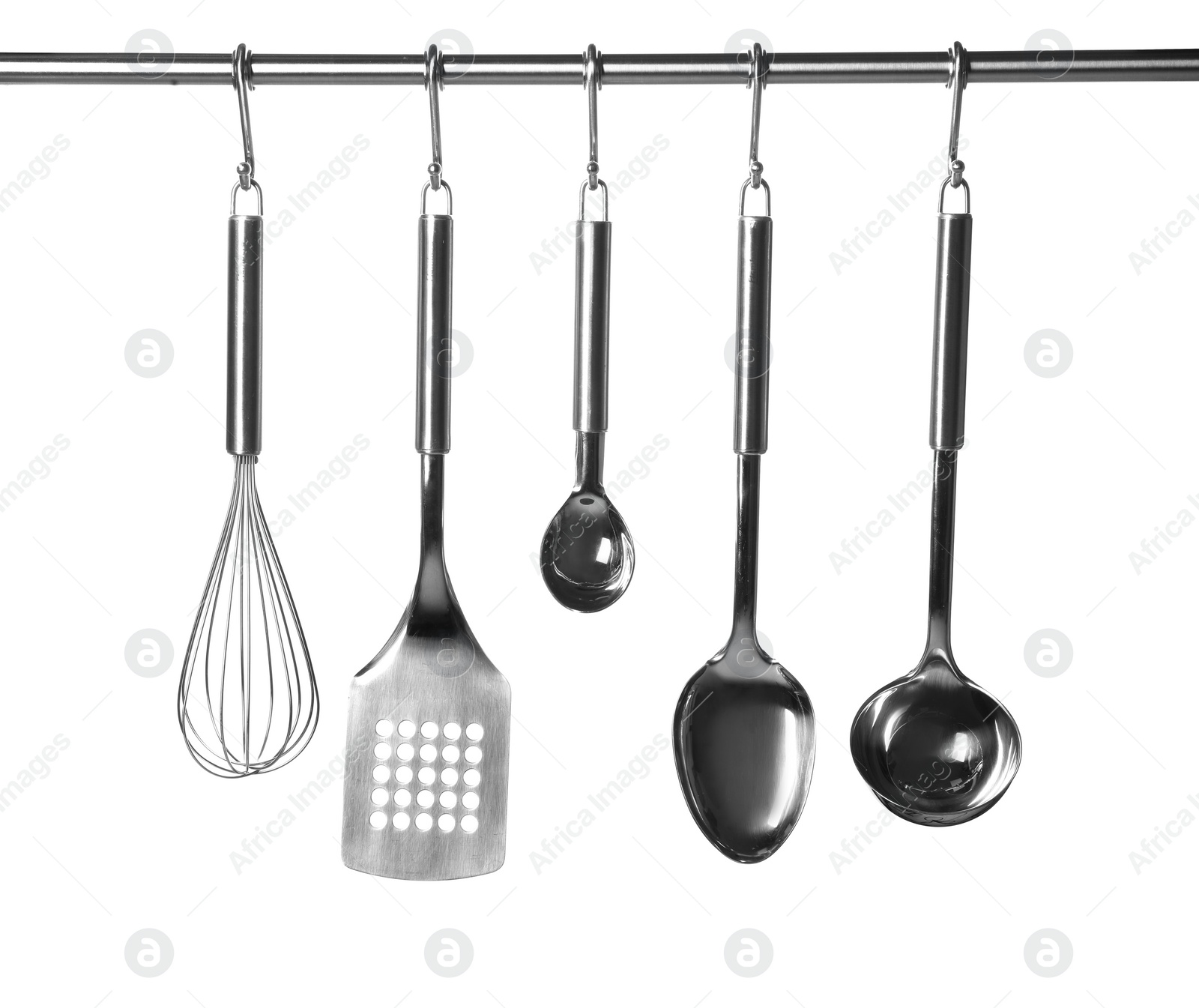 Photo of Set of kitchen utensils hanging against white background