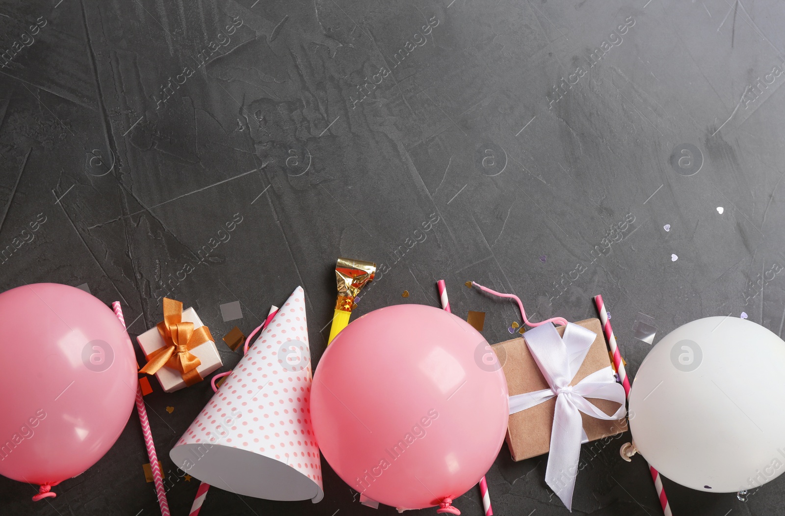 Photo of Flat lay composition with air balloons and space for text on dark background