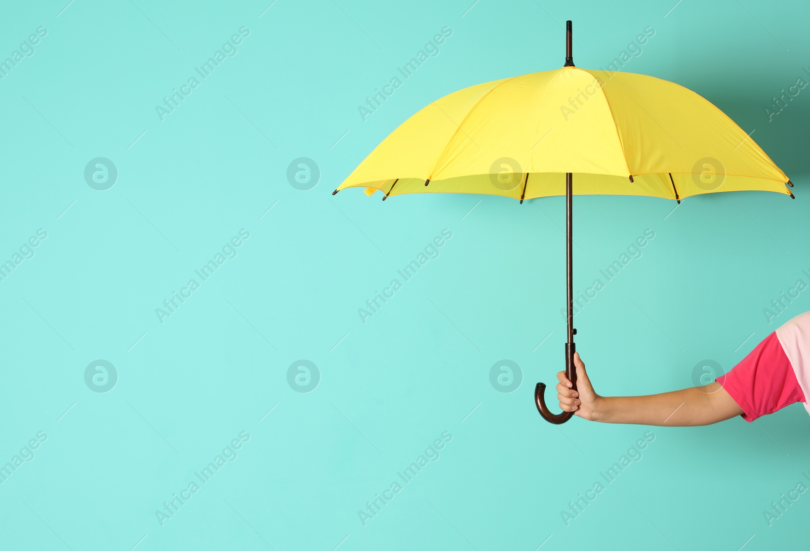 Photo of Woman holding beautiful umbrella on color background with space for design