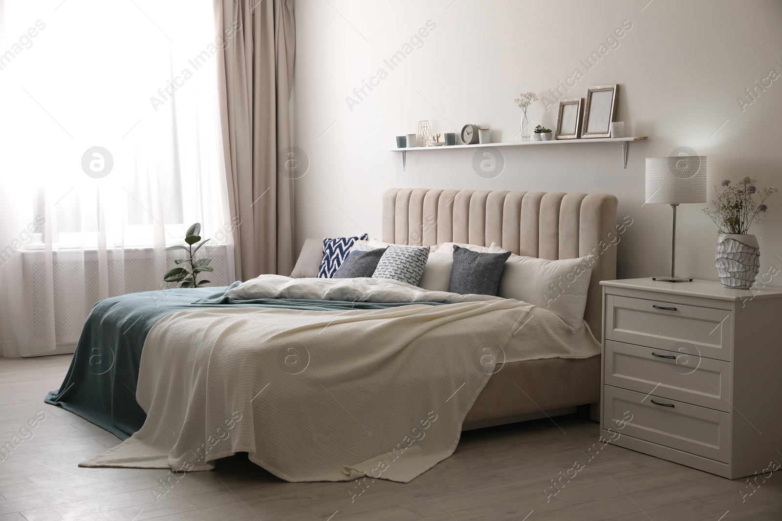 Photo of Comfortable bed with pillows in room. Stylish interior design