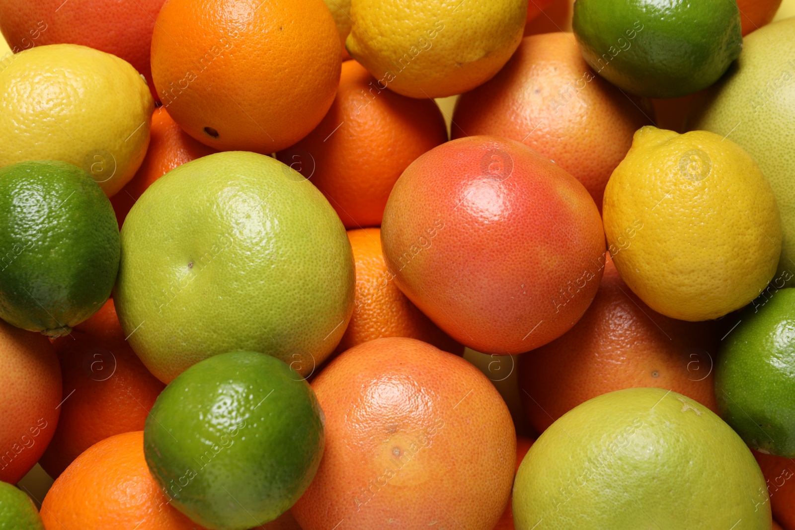 Photo of Different fresh citrus fruits as background, top view