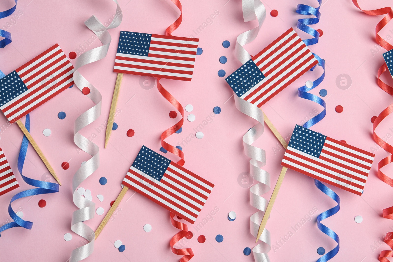 Photo of Flat lay composition with USA flags on color background. Happy Independence Day