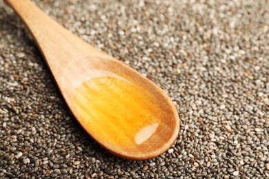 Spoon with chia oil on seeds, closeup. Space for text