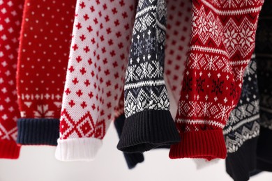 Photo of Closeup view of many different Christmas sweaters
