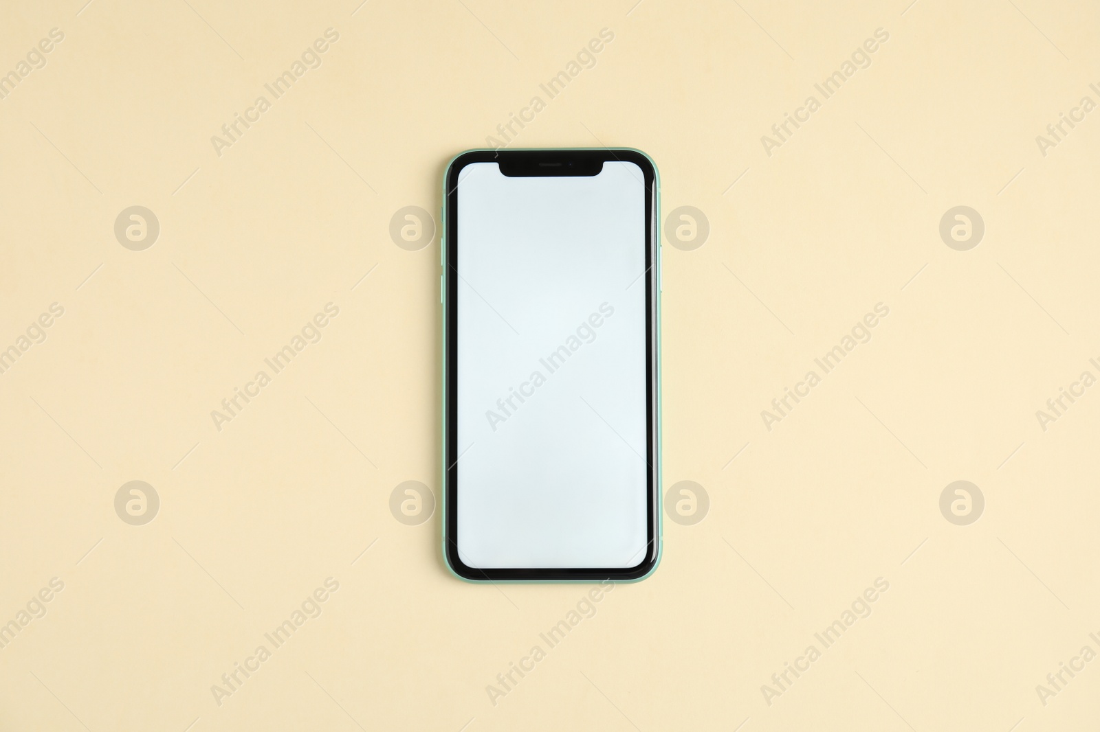 Photo of MYKOLAIV, UKRAINE - JULY 10, 2020: Iphone 11 with blank screen on beige background, top view. Mockup for design