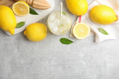 Cool freshly made lemonade and fruits on light grey table, flat lay. Space for text