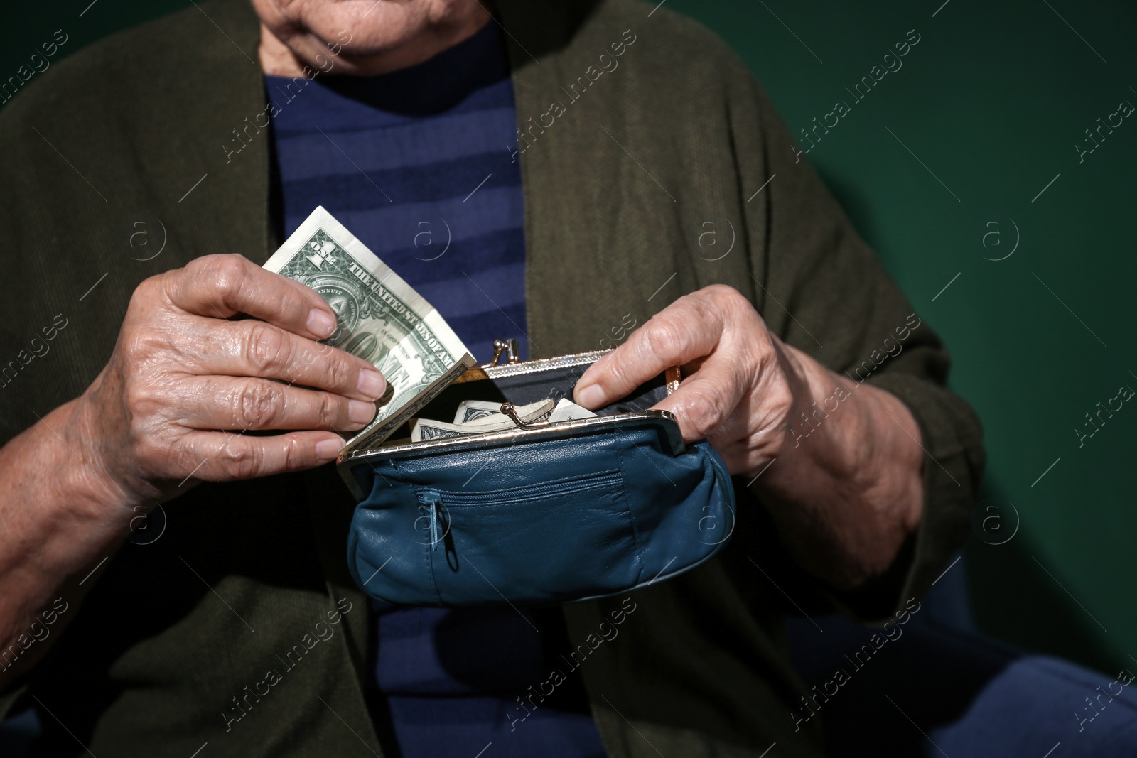 Photo of Poor senior woman with money on color background, closeup