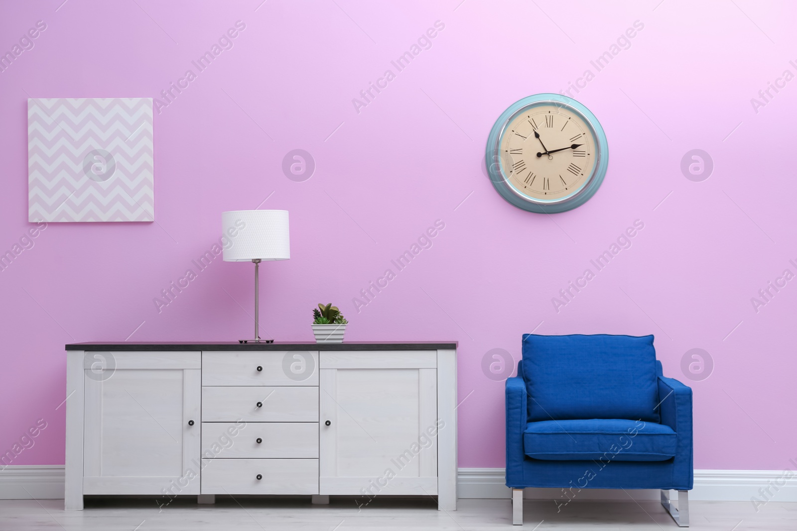 Photo of Room interior with stylish clock on wall. Time of day