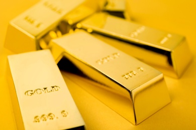 Photo of Precious shiny gold bars on color background