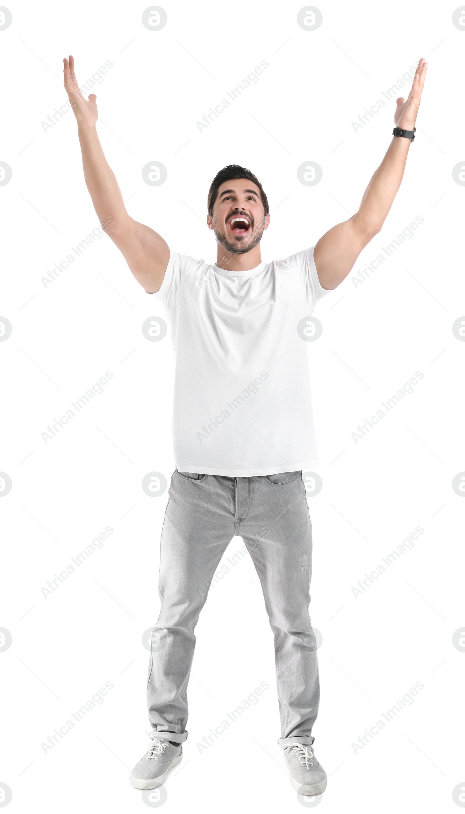 Photo of Happy young man with hands up on white background