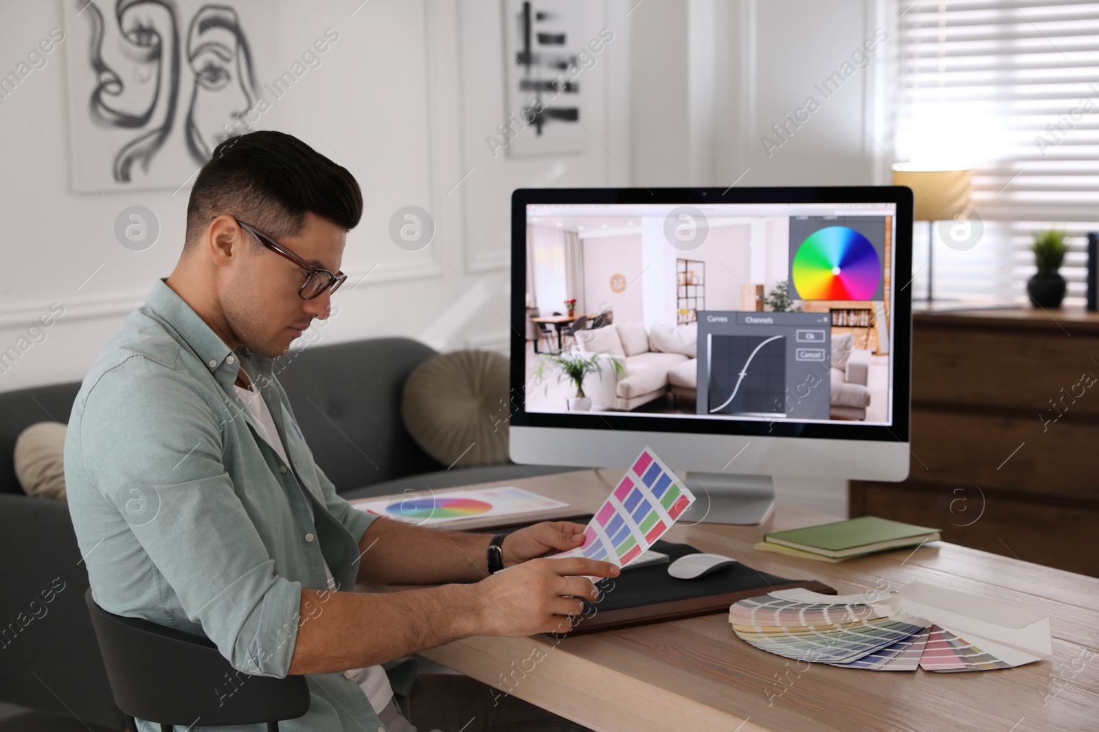 Photo of Professional retoucher working on computer in office