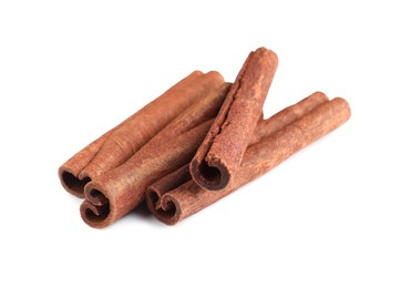 Photo of Many aromatic cinnamon sticks isolated on white