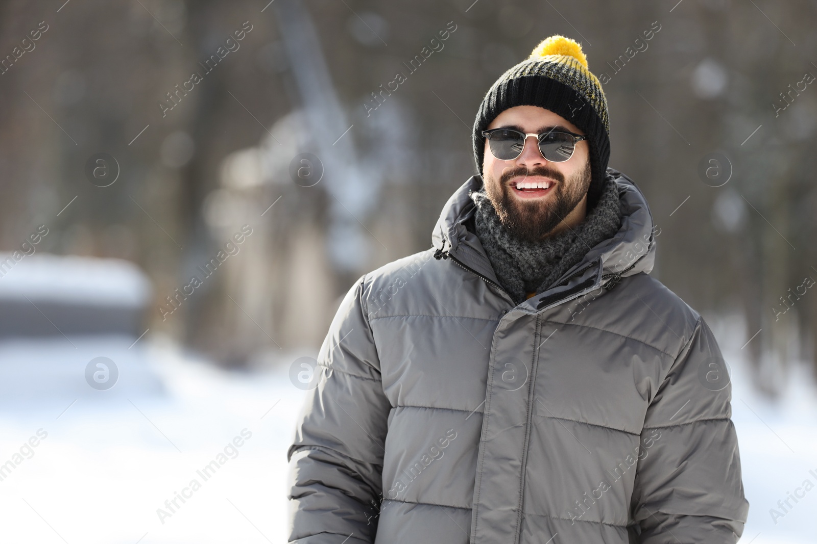 Photo of Portrait of handsome young man with sunglasses on winter day outdoors