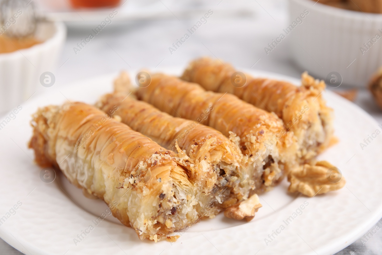 Photo of Eastern sweets. Pieces of tasty baklava on table, closeup