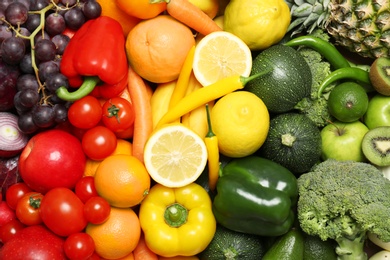 Photo of Rainbow collection of ripe fruits and vegetables as background, top view