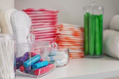Photo of Storage of different feminine hygiene products in cabinet