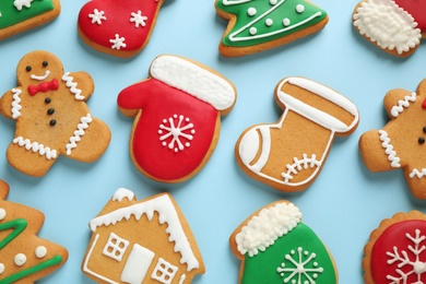 Flat lay composition with tasty homemade Christmas cookies on light blue background