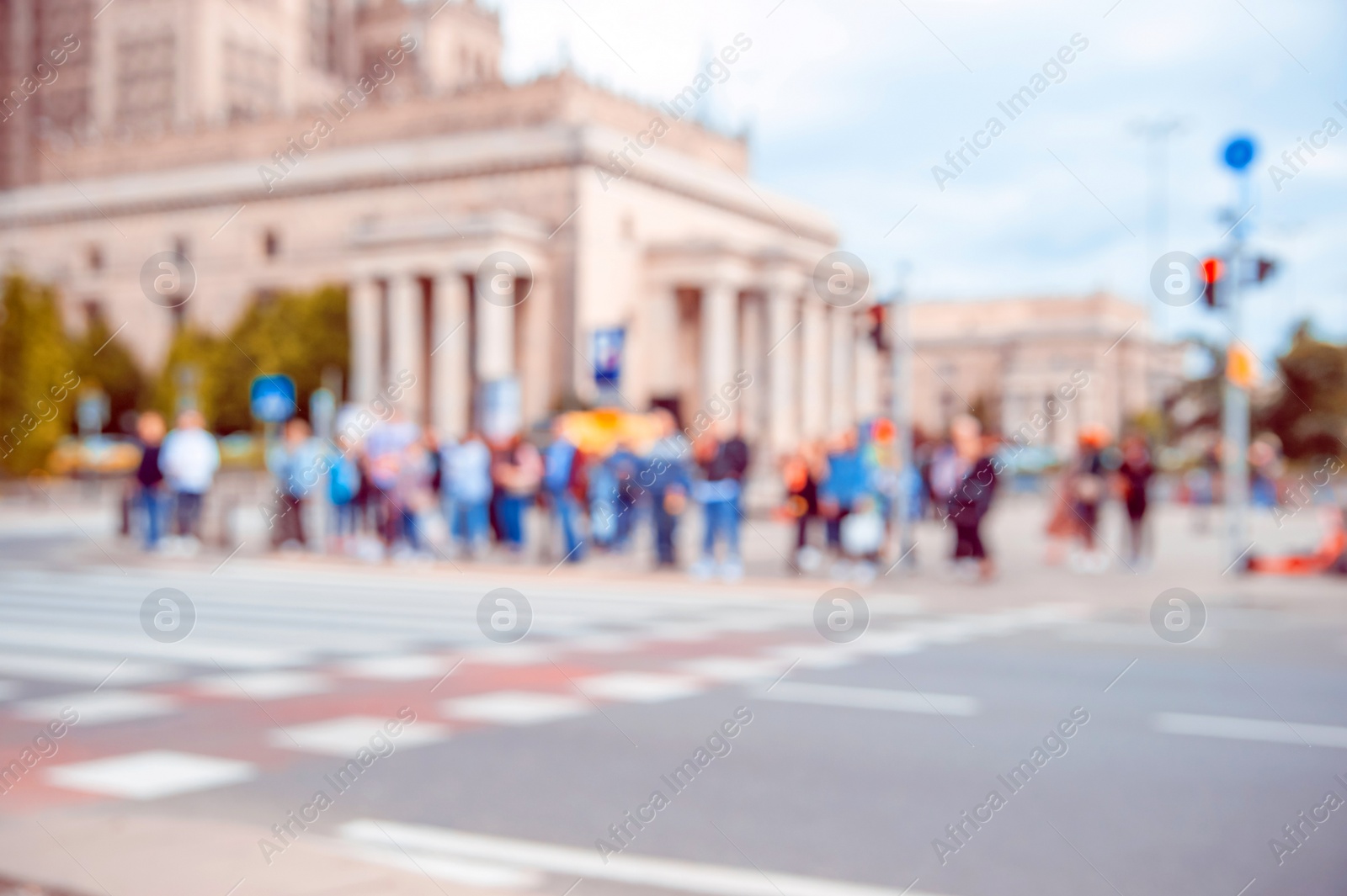 Photo of People waiting to cross street in city, blurred view