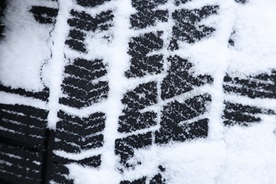 Winter tire covered with snow, closeup view