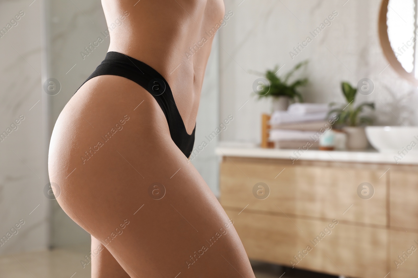 Photo of Closeup view of slim woman in underwear at home, space for text. Cellulite problem concept