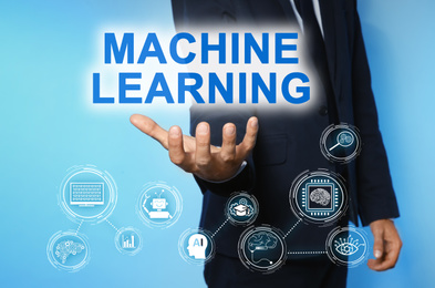 Man demonstrating machine learning model with linked icons on blue background, closeup