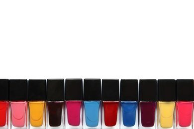 Photo of Bottles of nail polish on white background, top view