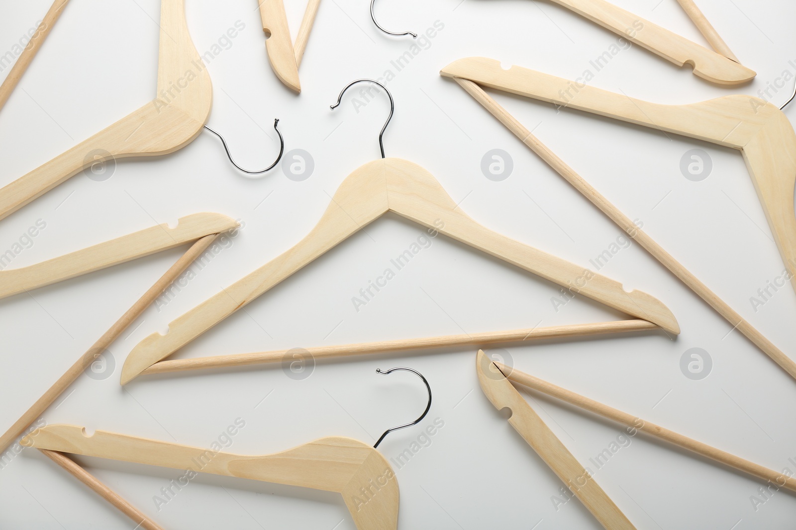 Photo of Wooden hangers on white background, flat lay