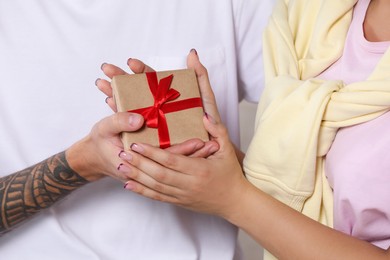 Photo of Lovely couple with beautiful gift, closeup view