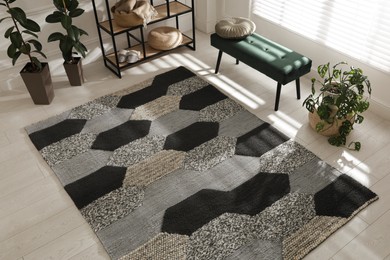 Photo of Stylish carpet with pattern on floor in room, above view