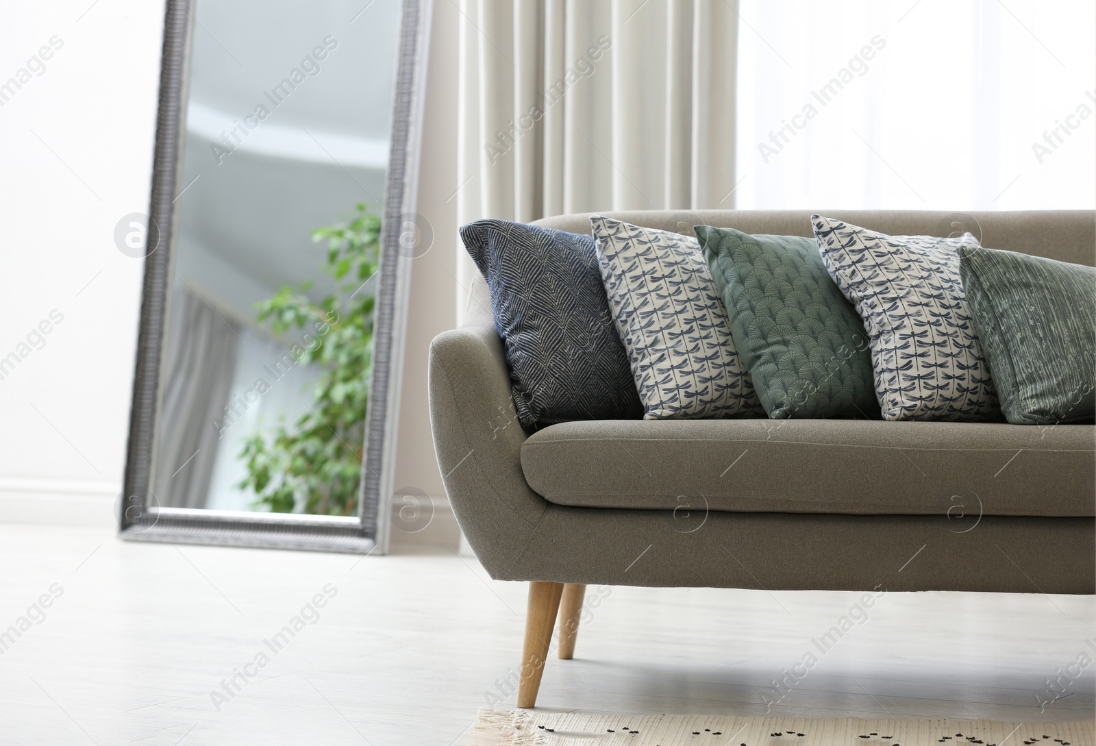 Photo of Sofa with pillows in modern living room interior