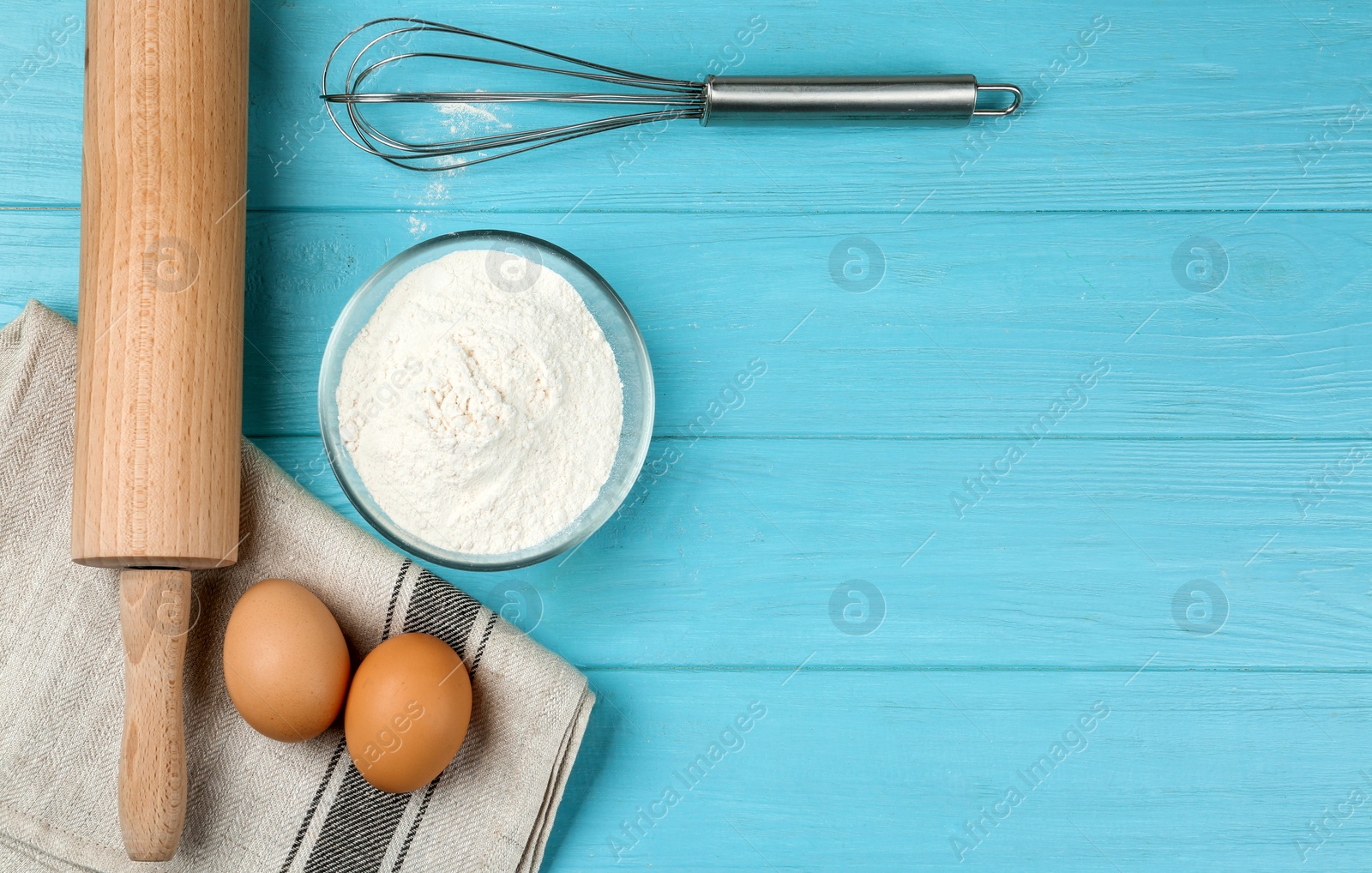 Photo of Flat lay composition with raw eggs on light blue wooden table, space for text. Baking pie