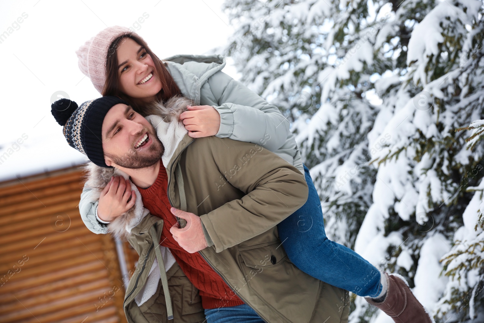 Photo of Lovely couple spending time together on snowy day. Winter vacation