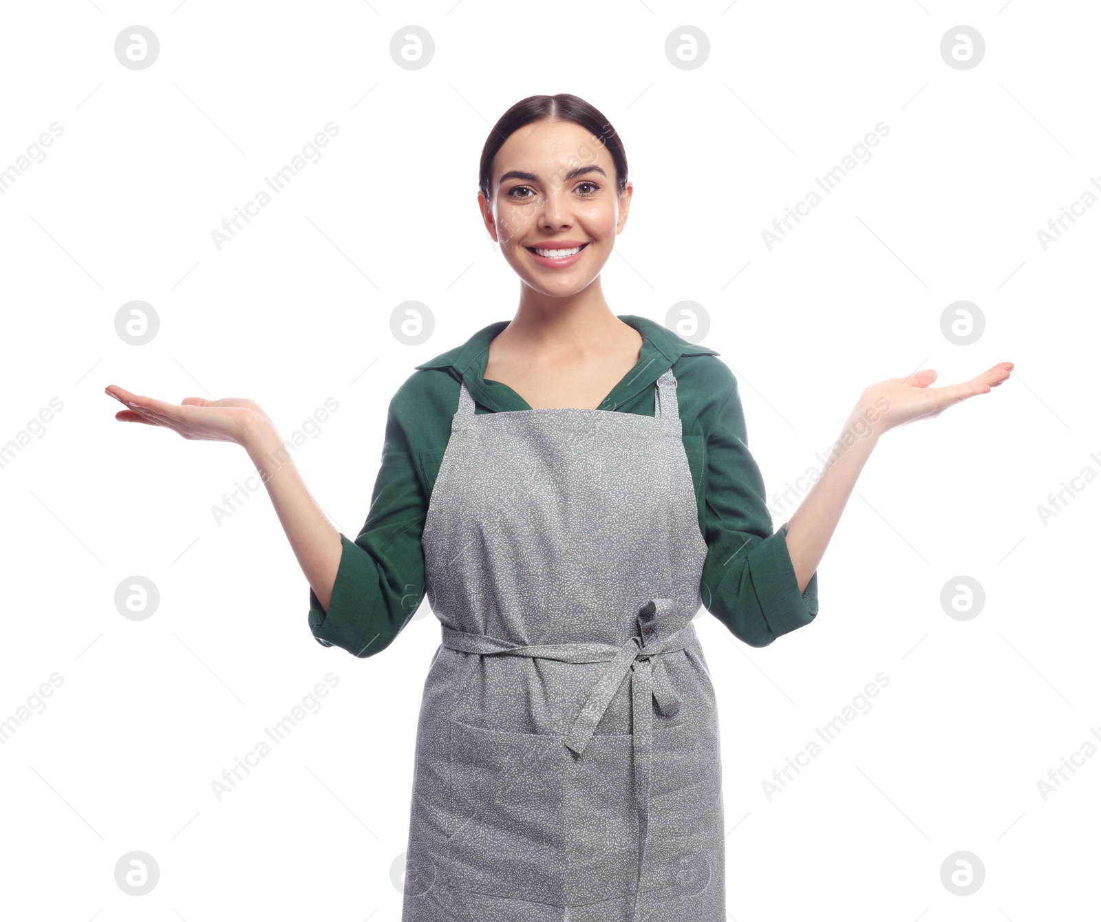 Photo of Young woman in grey apron on white background