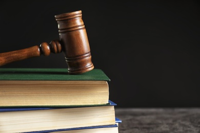 Judge's gavel and stack of books on table. Law concept