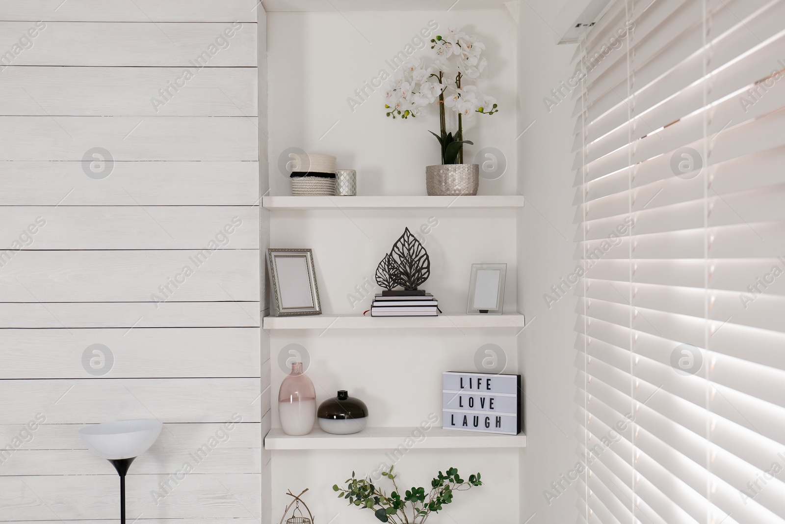 Photo of Wall shelves with beautiful decor elements indoors. Interior design