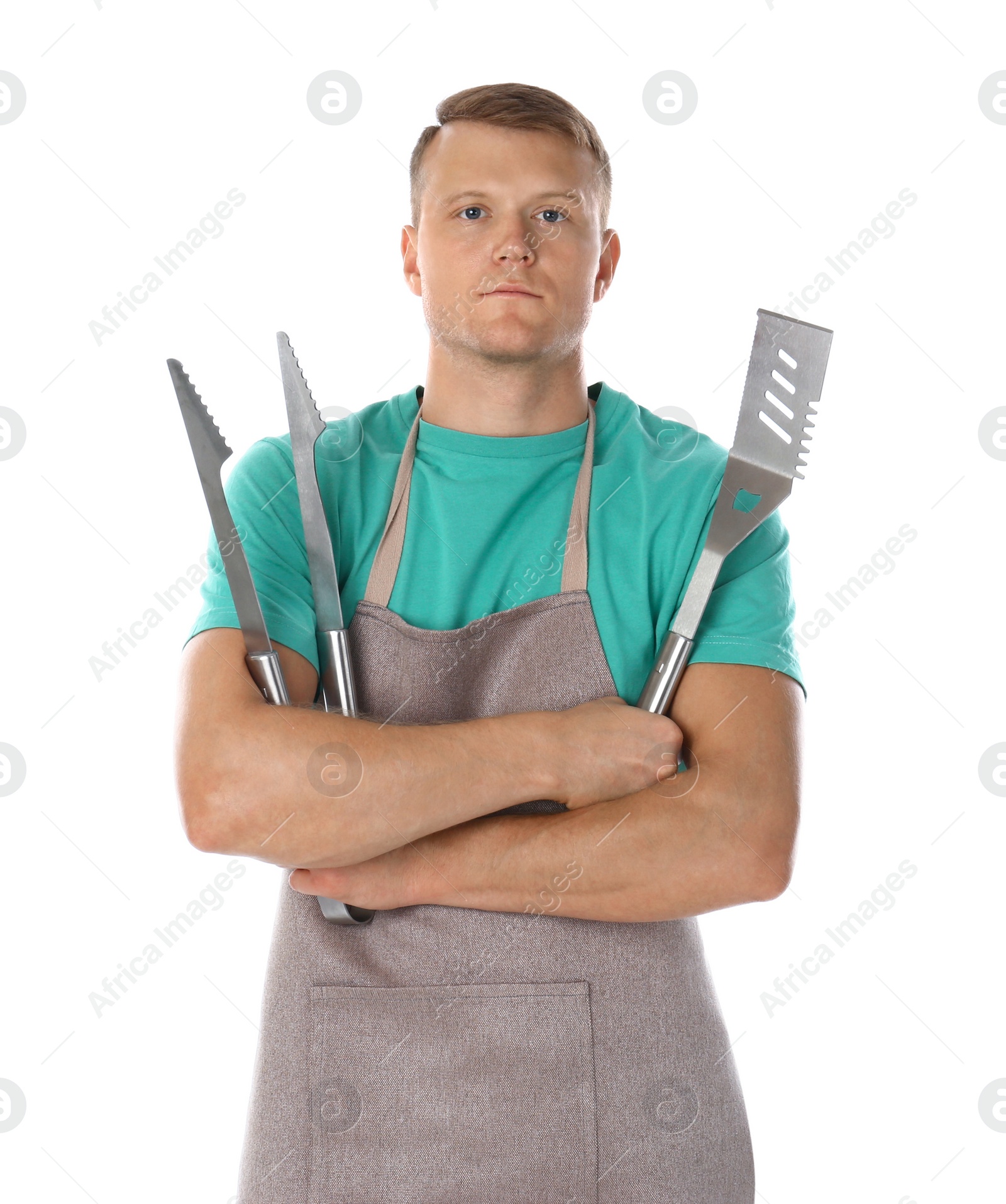 Photo of Man in apron with barbecue utensils on white background