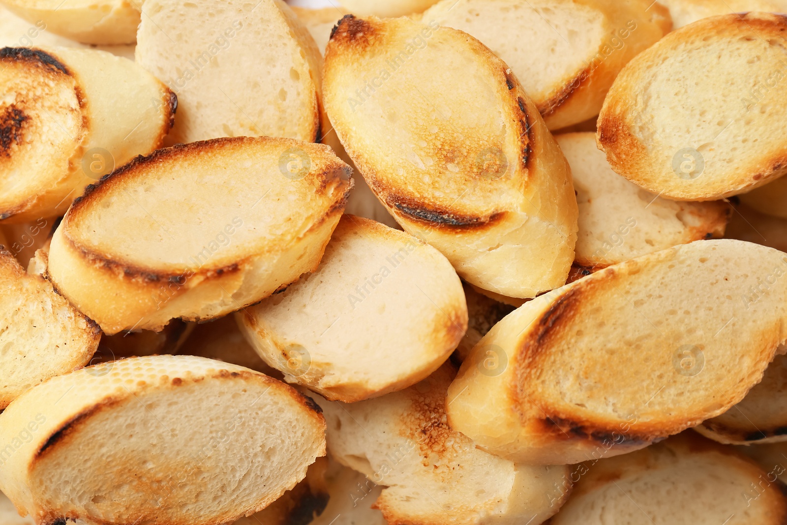 Photo of Toasted slices of bread as background, closeup