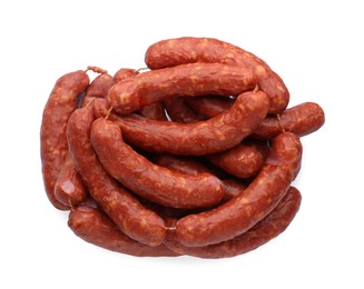 Photo of Many fresh raw sausages isolated on white, top view. Meat product