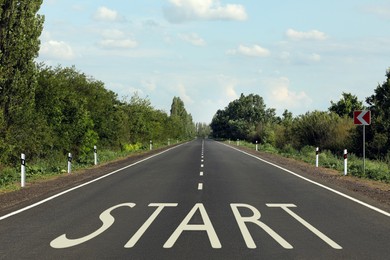 New beginnings. Word Start on asphalt road outdoors