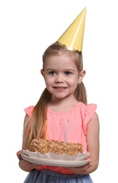 Photo of Birthday celebration. Cute little girl in party hat holding tasty cake on white background