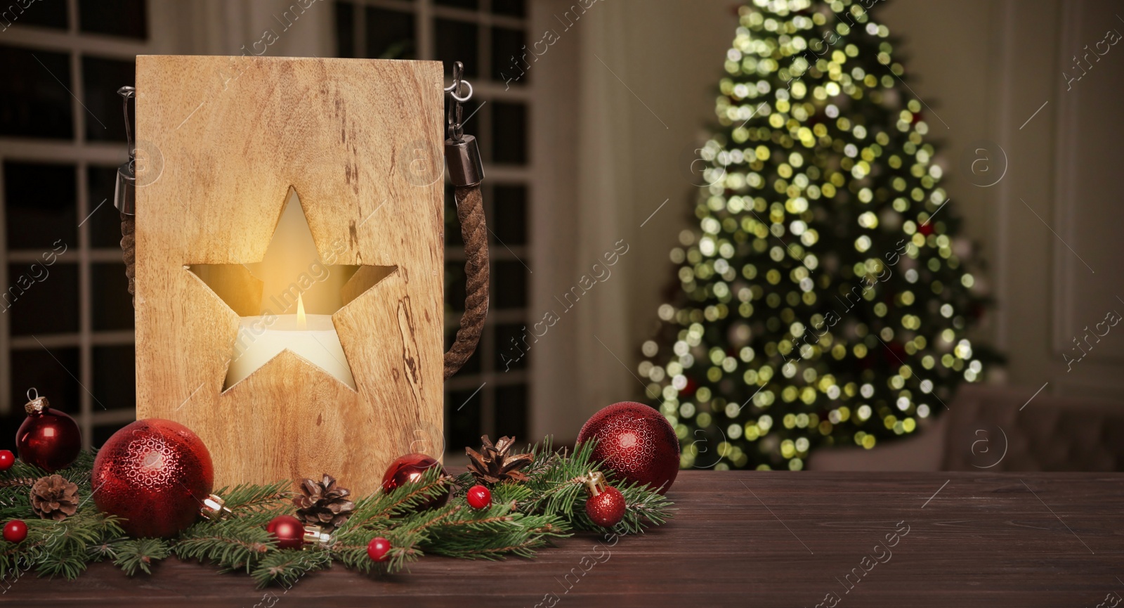 Image of Composition with Christmas lantern on table in decorated room, space for text