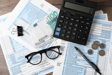 Photo of Tax accounting. Flat lay composition with calculator and documents on wooden table