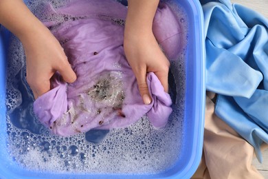 Photo of Woman washing garment with stain, top view