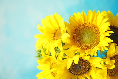 Photo of Bouquet of beautiful yellow sunflowers on color background