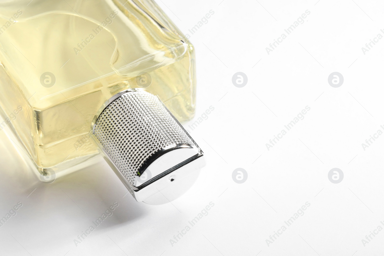 Photo of Luxury men`s perfume in bottle on white background, closeup. Space for text