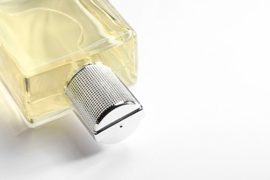 Luxury men`s perfume in bottle on white background, closeup. Space for text