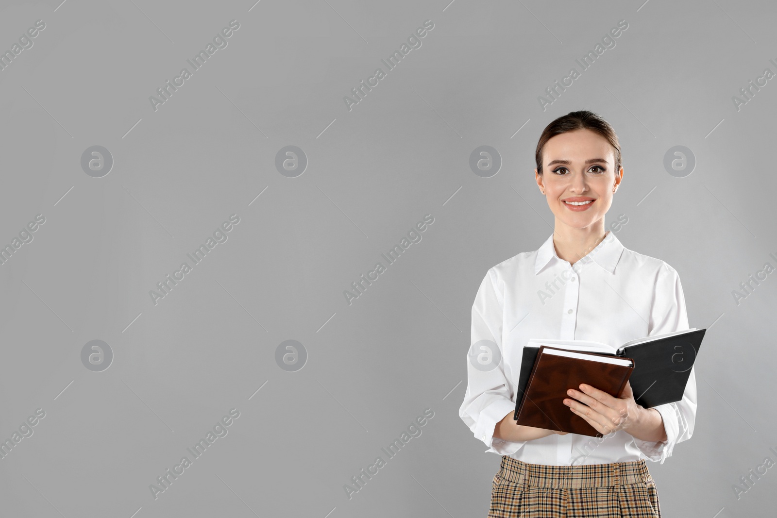 Photo of Portrait of young female teacher on grey background. Space for text