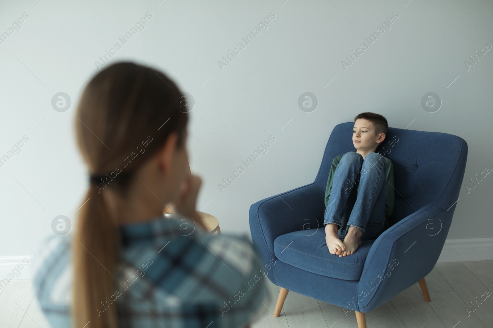 Photo of Sad boy and his worried mother at home