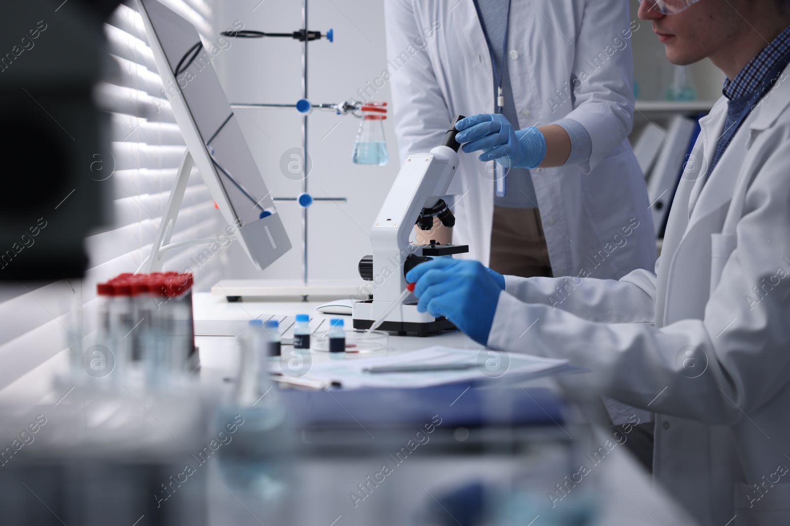 Photo of Scientists working with samples in laboratory, closeup. Medical research