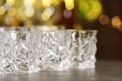 Photo of Empty glasses on table against blurred background